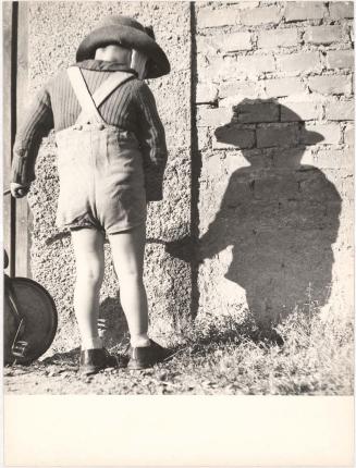 Boy facing a wall, Italy